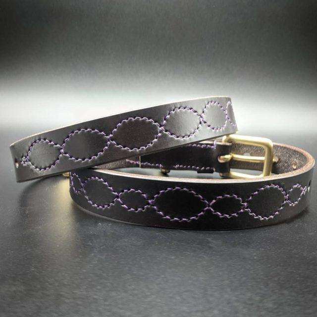 Bespoke//Dog collars//Dark Havana with fancy purple stitching//A pair of collars made for this customers spaniels, identical apart from the fancy patterns to differentiate between dogs